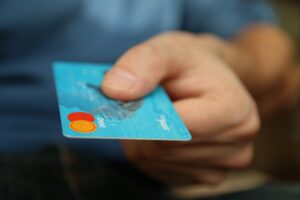 Hands Exchanging Credit Card Penny Forward hand reaching out with a credit card