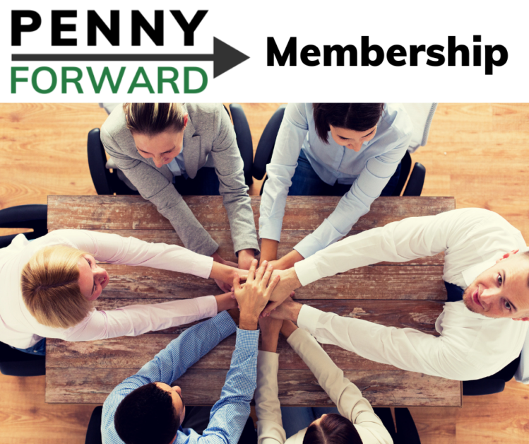 A group of people sitting at a table with their hands stacked on top of each other.